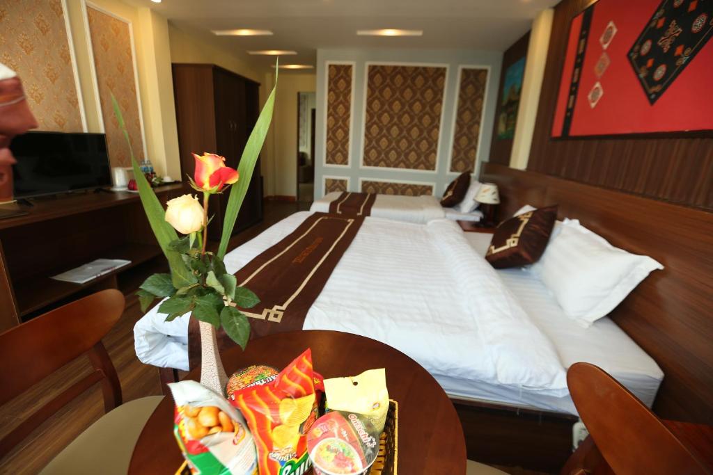 Postel nebo postele na pokoji v ubytování Sapa Unique Hotel