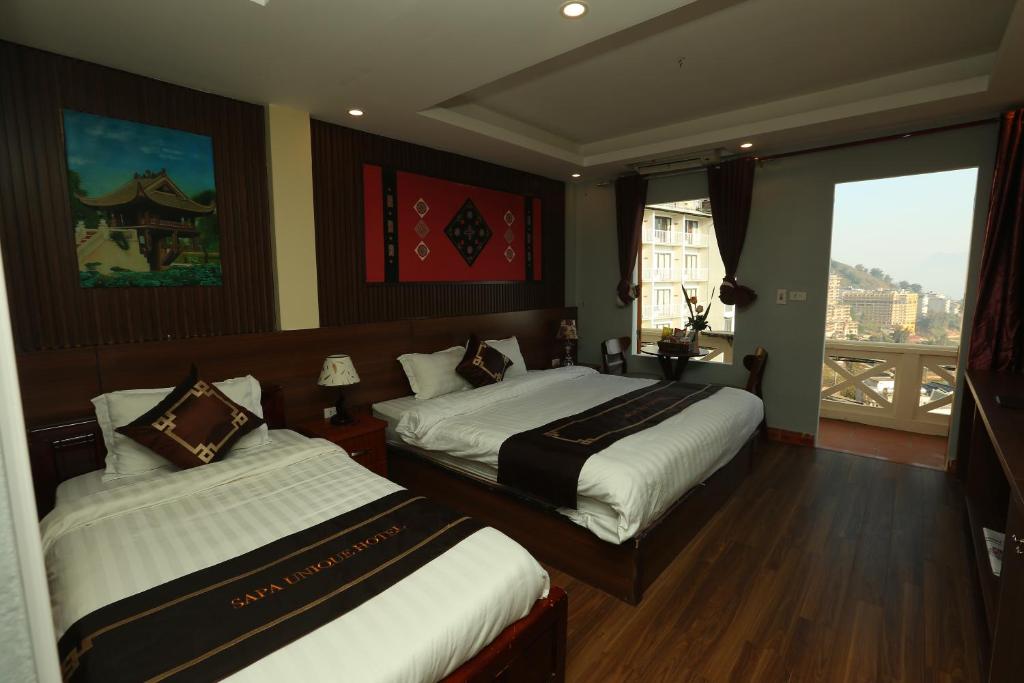 Postel nebo postele na pokoji v ubytování Sapa Unique Hotel