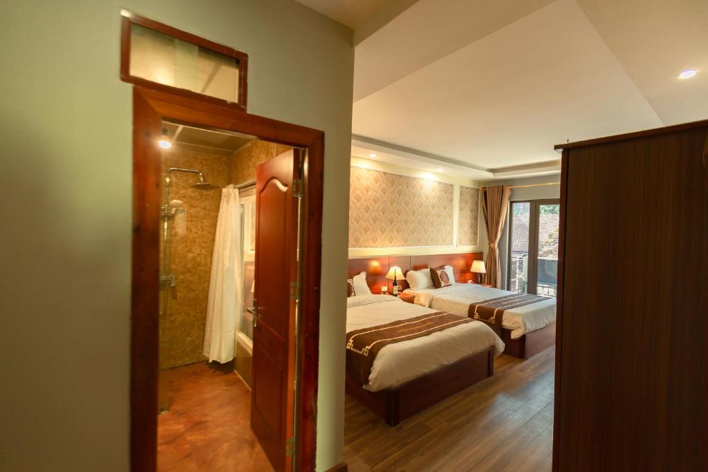 Postel nebo postele na pokoji v ubytování Sapa Unique Hotel