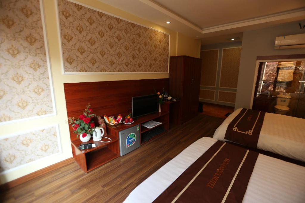 Postel nebo postele na pokoji v ubytování Sapa Unique Hotel