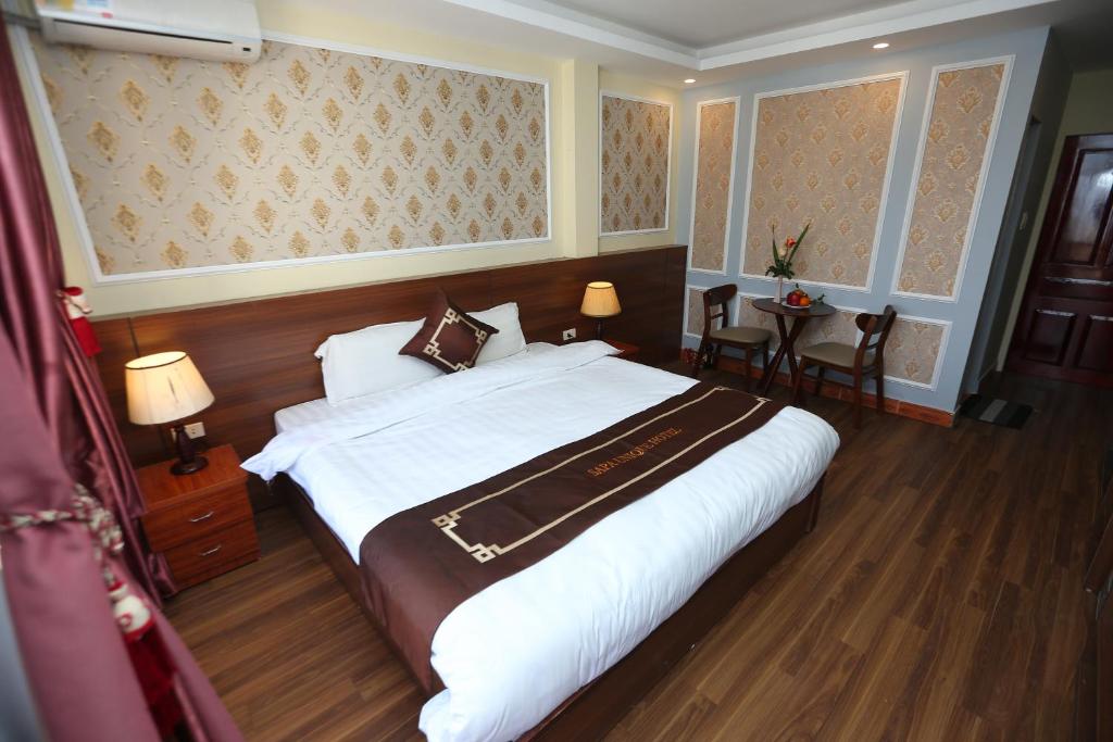 Postel nebo postele na pokoji v ubytování Sapa Unique Hotel