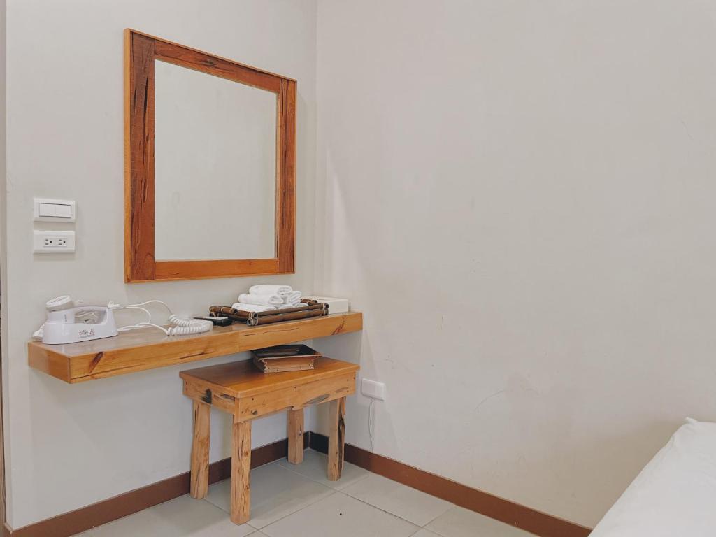 a bathroom with a mirror and a wooden table at Star-Moon B&amp;B Green Island in Green Island
