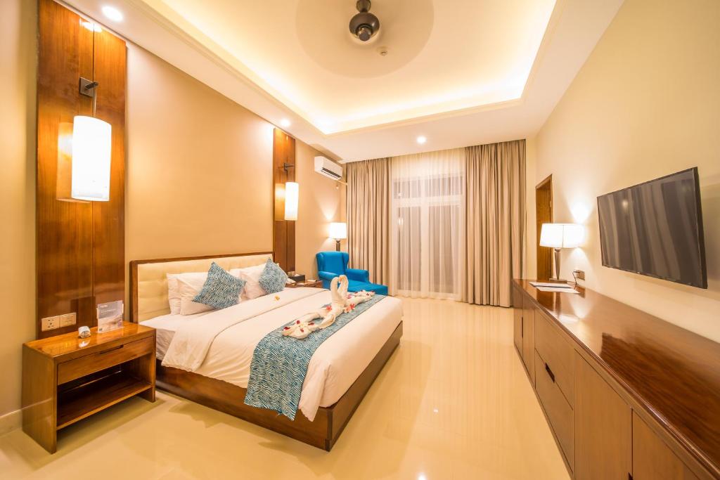 En eller flere senger på et rom på NDC Resort & Spa