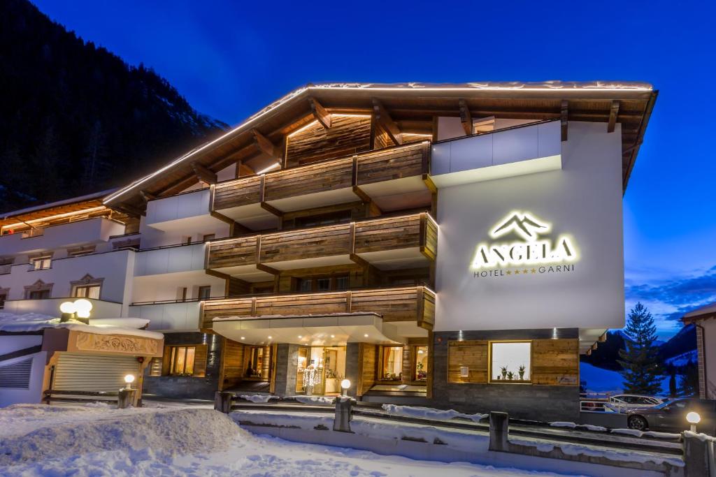 a hotel in the snow at night at Hotel Garni Angela in Ischgl