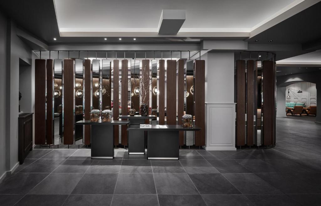 a room with two tables and a wine cellar at Schwarzer Adler Kitzbühel - Adults Only in Kitzbühel