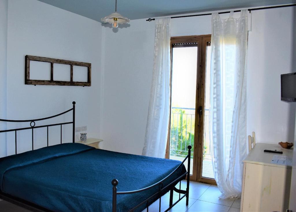 Postel nebo postele na pokoji v ubytování Casolare Azzurro