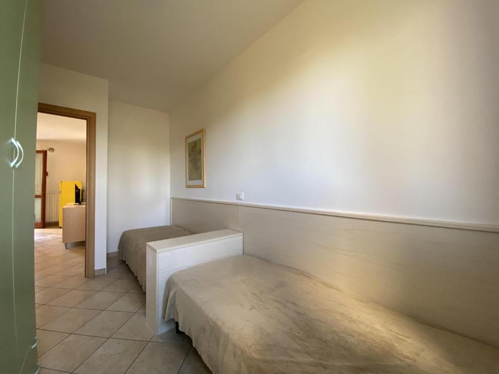 A bed or beds in a room at Immobiliare JVL - Le Ginestre