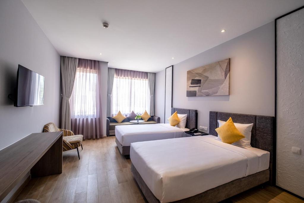 Seava Ho Tram Beach Resort tesisinde bir odada yatak veya yataklar