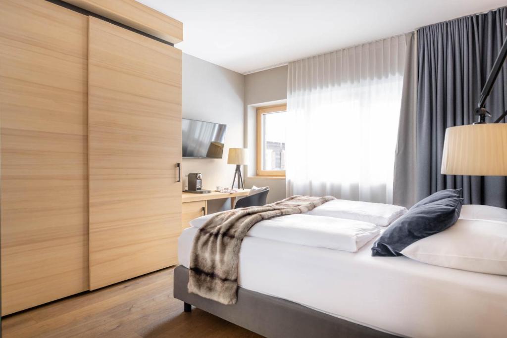 Postel nebo postele na pokoji v ubytování Sporthotel Chalet