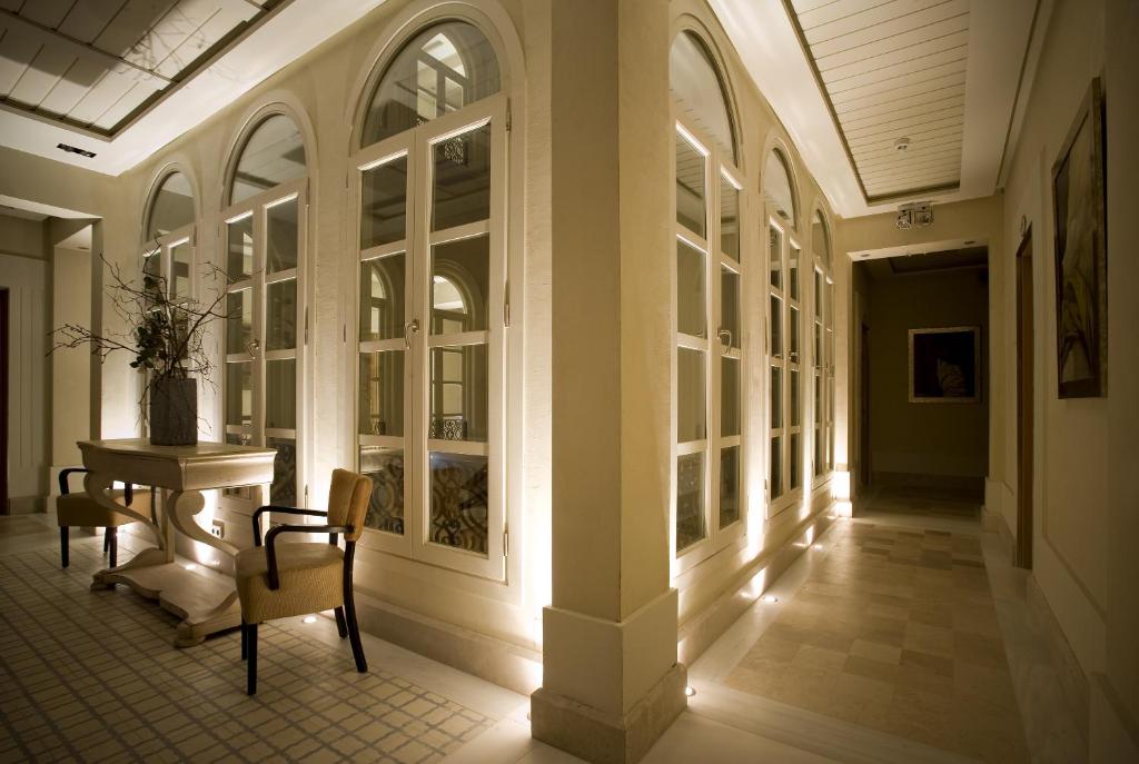a hallway with a table and chairs in a building at Villa Oniria in Granada