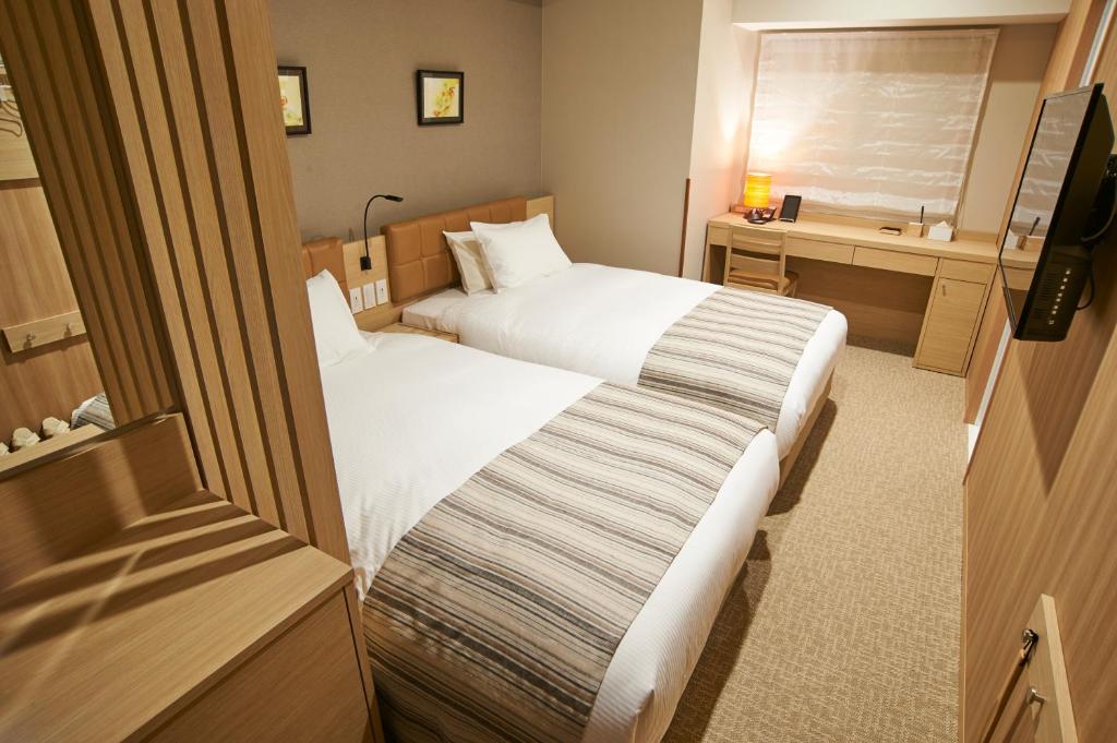 Postel nebo postele na pokoji v ubytování QuintessaHotel TokyoHaneda Comic&Books