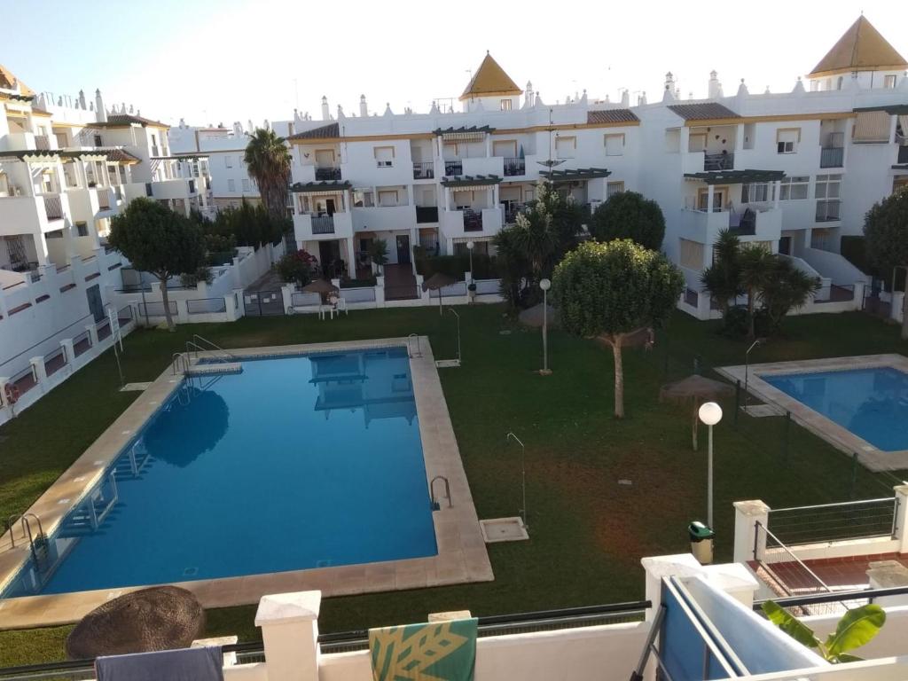 a view of a swimming pool in a apartment at Apartamento La Atalaya C-162 in Conil de la Frontera