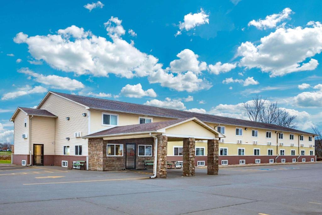 a large building with a parking lot in front of it at Super 8 by Wyndham Fort Madison in Fort Madison