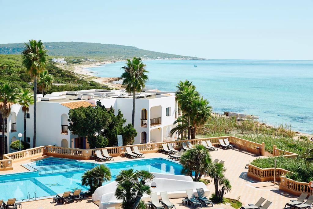 an aerial view of a resort with a pool and the ocean at Insotel Hotel Formentera Playa in Playa Migjorn