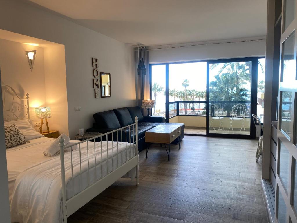 a bedroom with a bed and a living room at Aloha Playa in Benalmádena