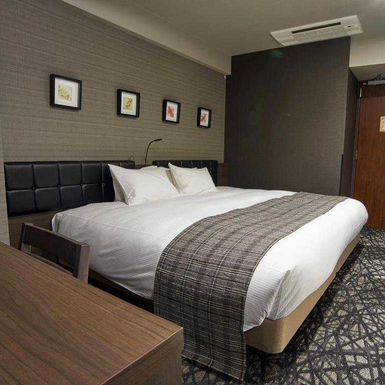 Postel nebo postele na pokoji v ubytování QuintessaHotel TokyoHaneda Comic&Books