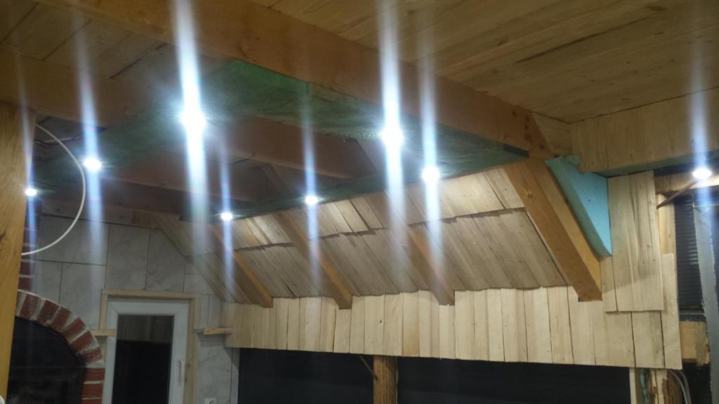 a wooden ceiling in a room with lights on it at Studio apartman Jelovac in Nišići