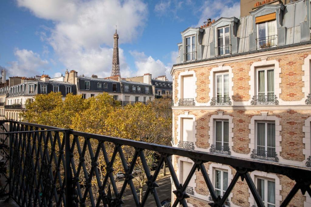a view of the eiffel tower from a bridge at Hotel Relais Bosquet by Malone in Paris