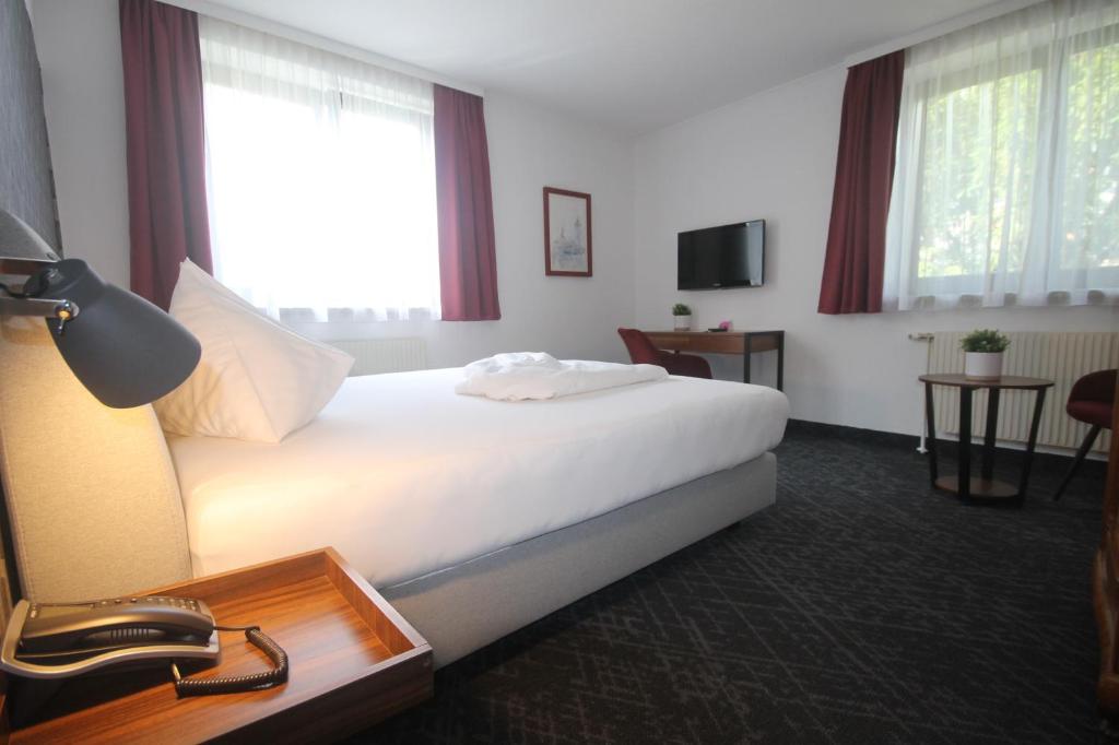 Postel nebo postele na pokoji v ubytování Hotel Altmann