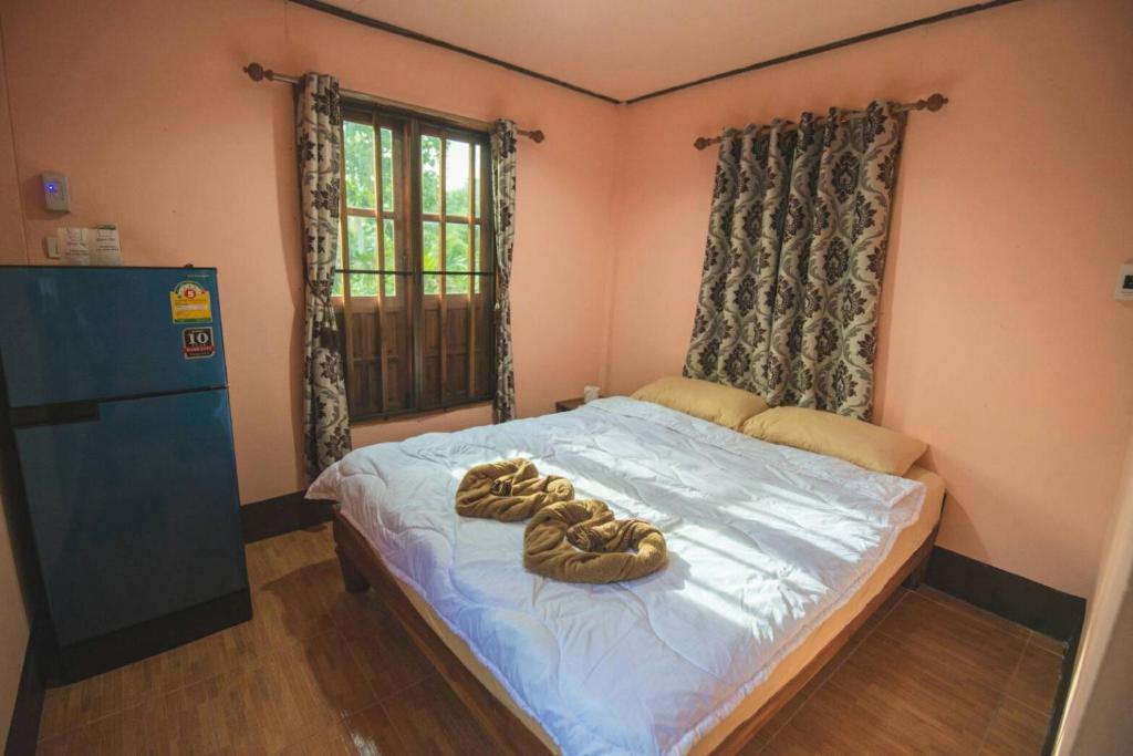 Postel nebo postele na pokoji v ubytování NonKan HomeStay นอนกาญจน์ โฮมสเตย์