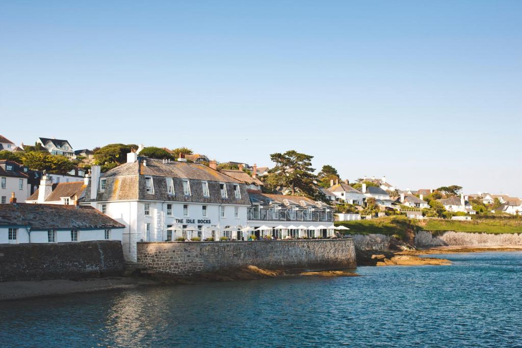a group of buildings on the side of a river at The Idle Rocks in Saint Mawes