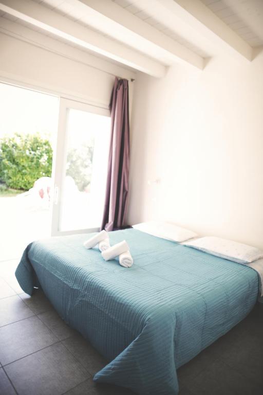 Łóżko lub łóżka w pokoju w obiekcie Agriturismo Beatilla
