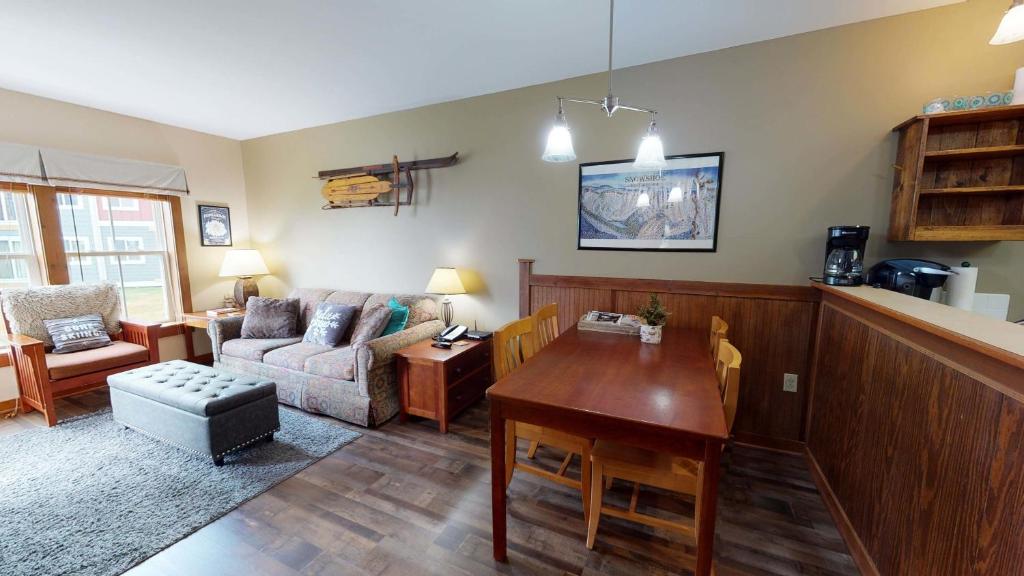 a living room with a table and a couch at Allegheny Spg - Cozy Condo Ski from our patio in Dunmore