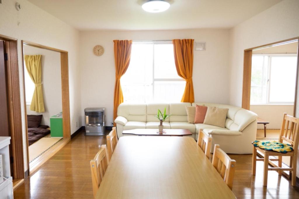 a living room with a couch and a table at Maeda Forestry House - Vacation STAY 19184v in Furano