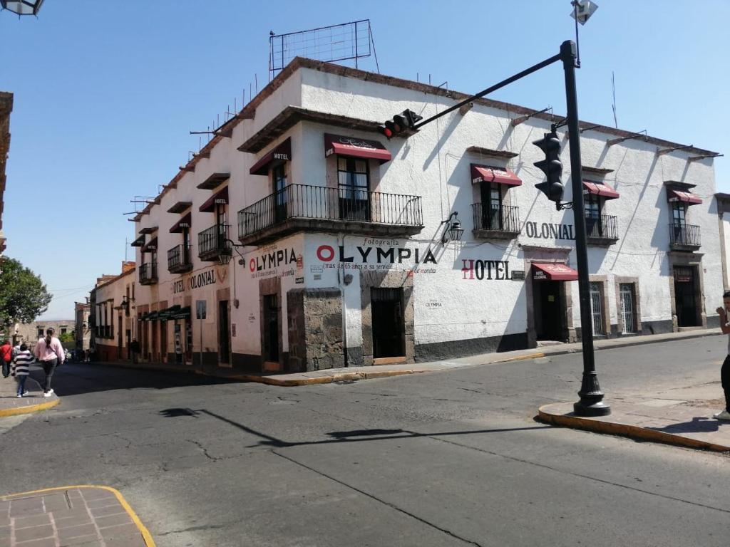 un edificio en la esquina de una calle con un semáforo en Hotel Colonial, en Morelia