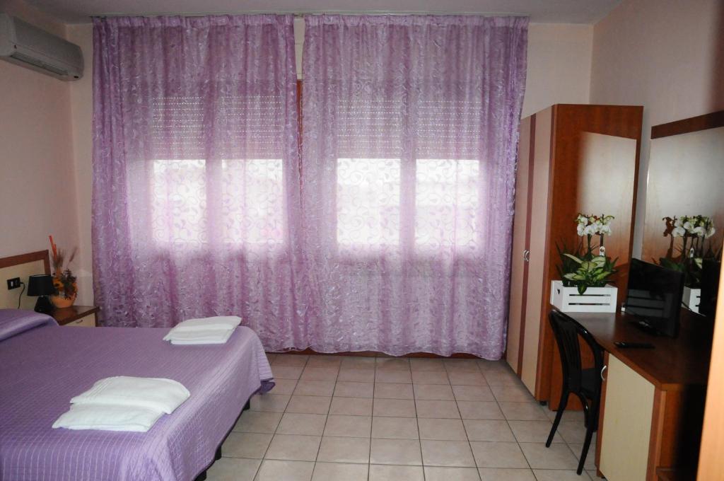 Postel nebo postele na pokoji v ubytování Hotel Cippa’s
