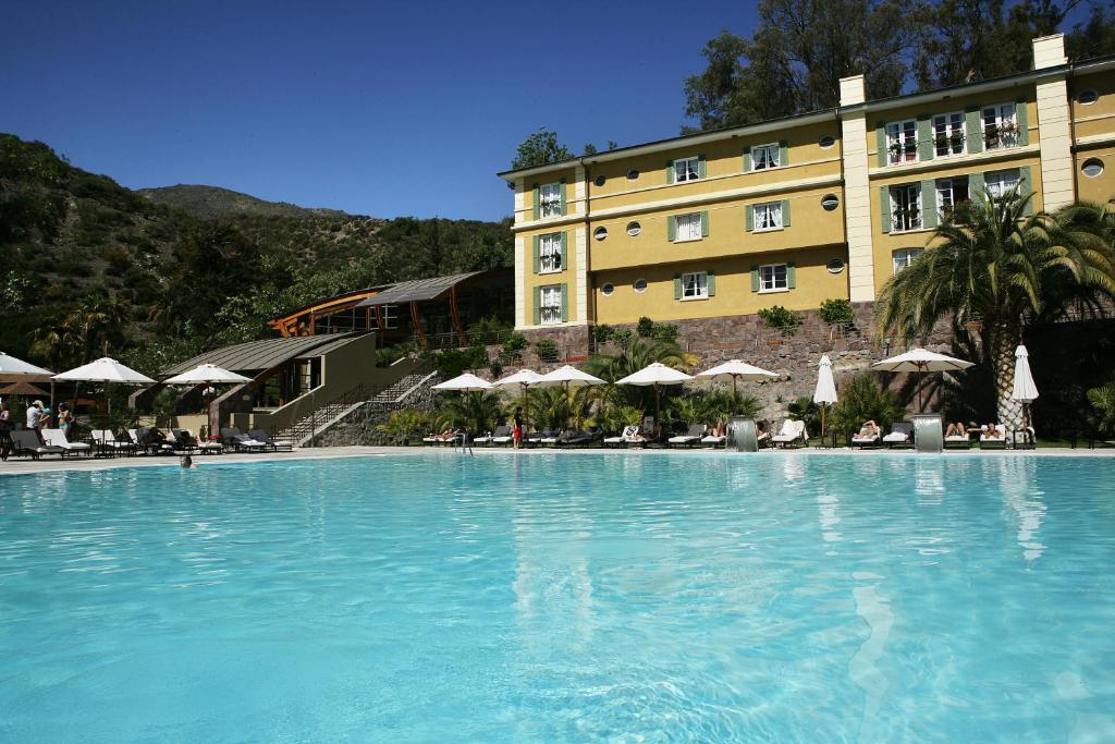 a large swimming pool in front of a hotel at Termas de Jahuel Hotel & Spa in Santa María