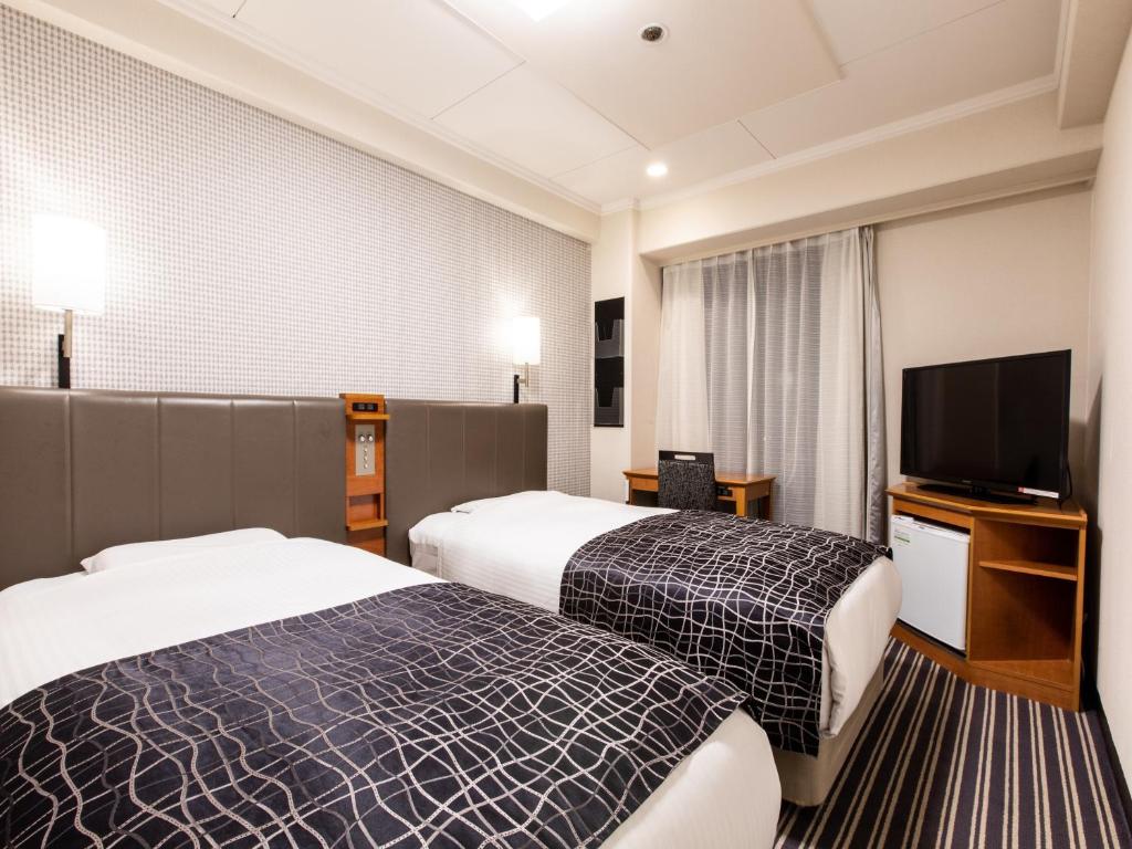 Postel nebo postele na pokoji v ubytování APA Hotel Kyoto Gion Excellent