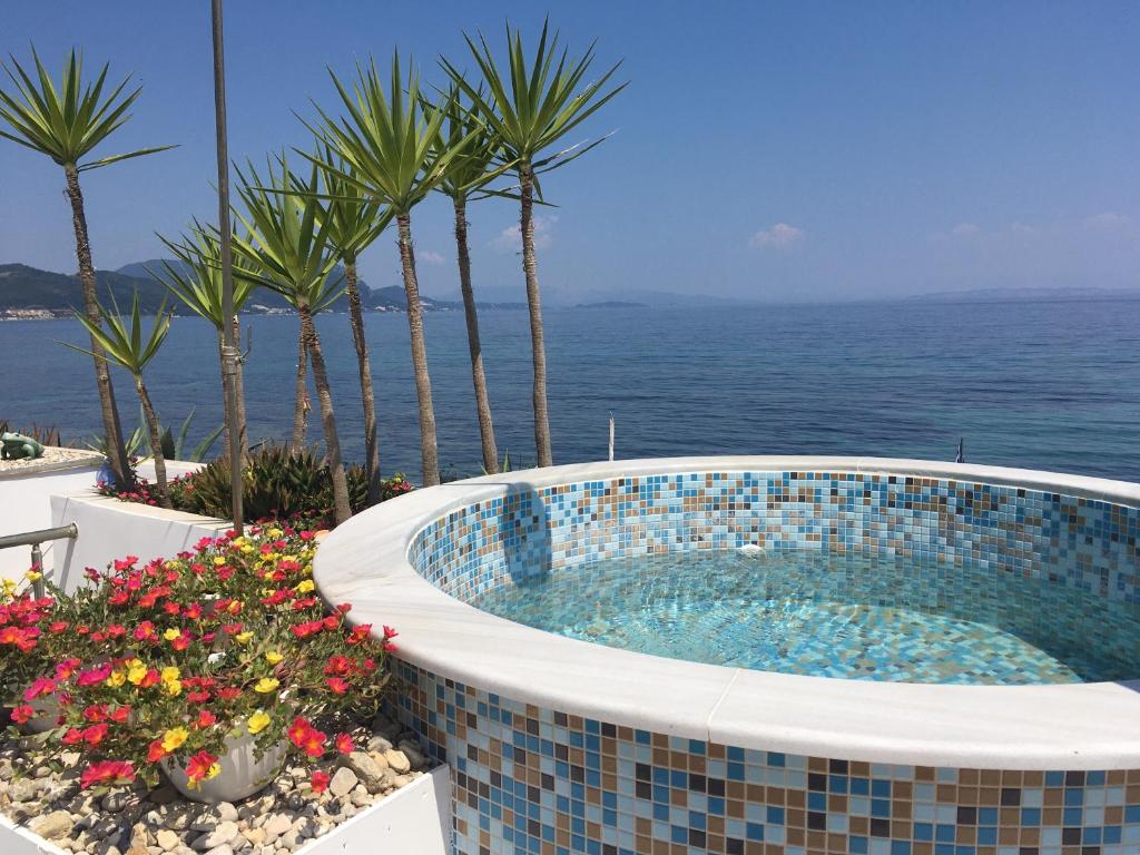 a swimming pool with the ocean in the background at Villa Evita in Mesongi