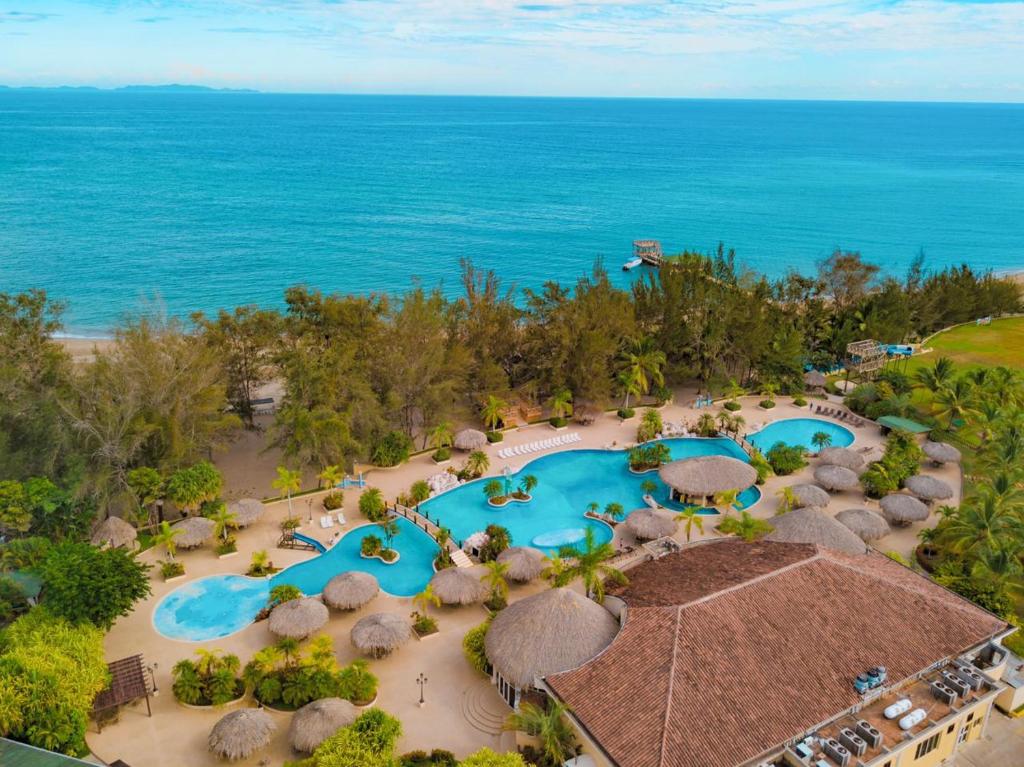 an aerial view of a resort with two swimming pools at La Ensenada Beach Resort in Tela