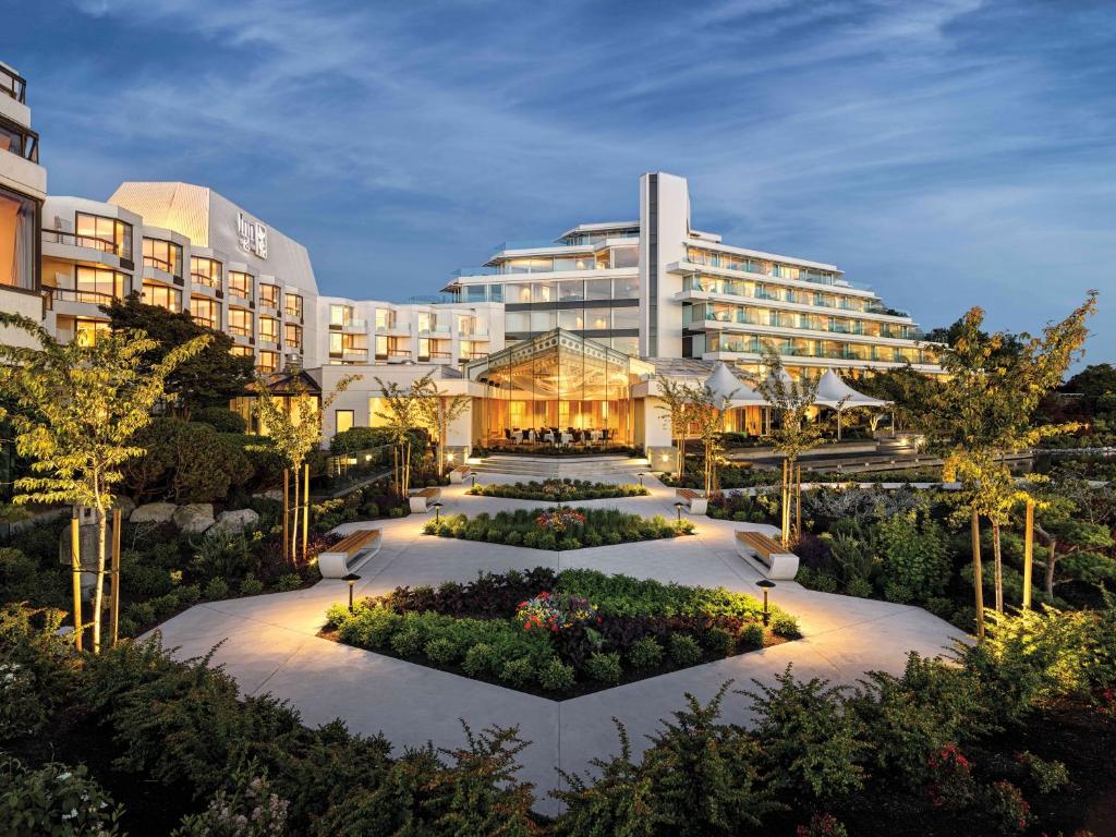 a hotel with a garden in front of a building at Inn at Laurel Point in Victoria