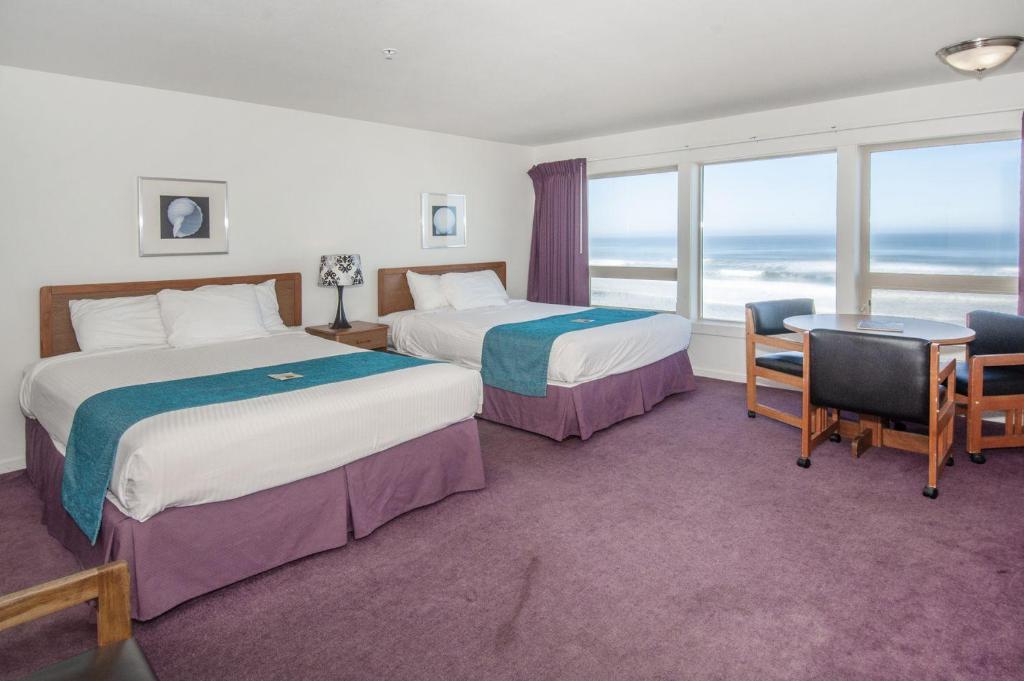 a hotel room with two beds and a view of the ocean at Seahorse Oceanfront Lodging in Lincoln City