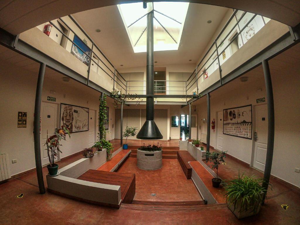 a large room with benches and plants in a building at Folk Suites in El Calafate