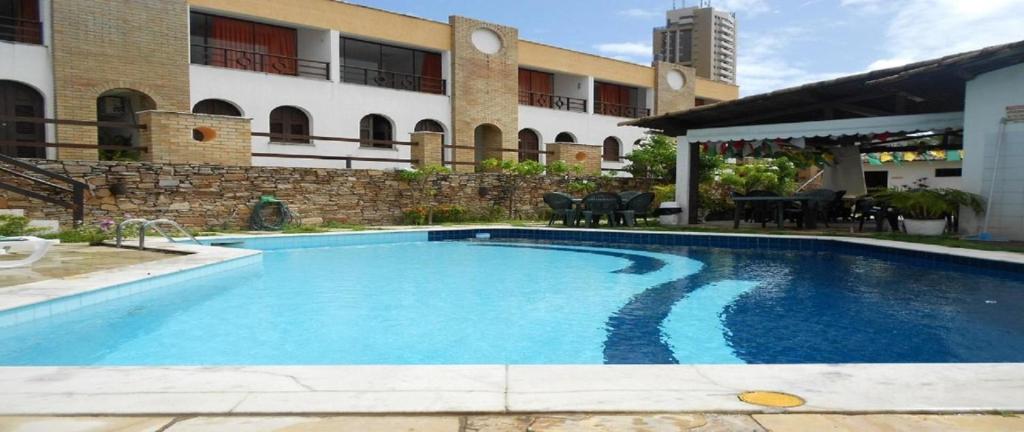a swimming pool in front of a building at PontaNegra Ponta do Sol 5D Luciene Vista deslumbrante para o mar in Natal
