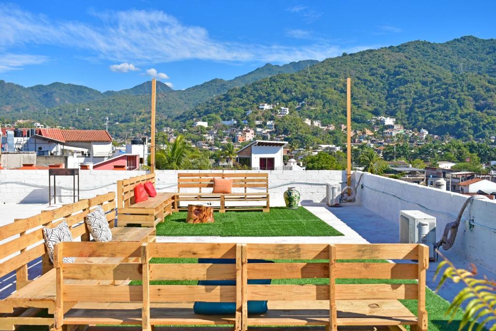 a patio with benches and a table on a roof at Hotel Blue Home Vallarta in Puerto Vallarta