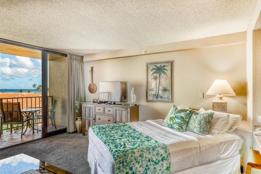 a hotel room with a bed and a balcony at Kaanapali Shores 732 in Kahana