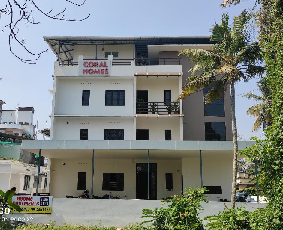 a building with a sign that reads coral home at Coral Homes in Cochin