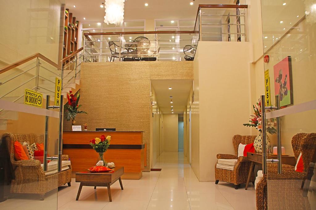 a lobby with chairs and tables in a store at Thirdys Tourist Inn in Legazpi