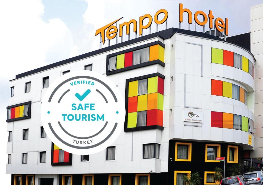 a hotel with a sign on the side of it at Tempo Hotel Caglayan in Istanbul