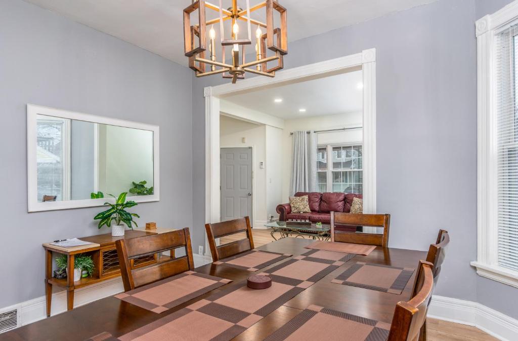 a dining room with a table and chairs and a chandelier at Beautiful Apartment on the west side in Buffalo in Buffalo