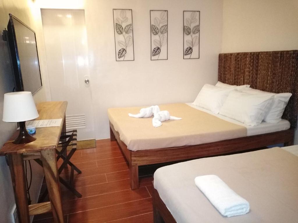 Postel nebo postele na pokoji v ubytování Thirdys Tourist Inn