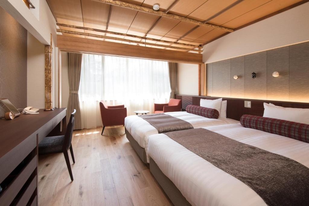 Postel nebo postele na pokoji v ubytování Kamikochi Hotel Shirakabaso