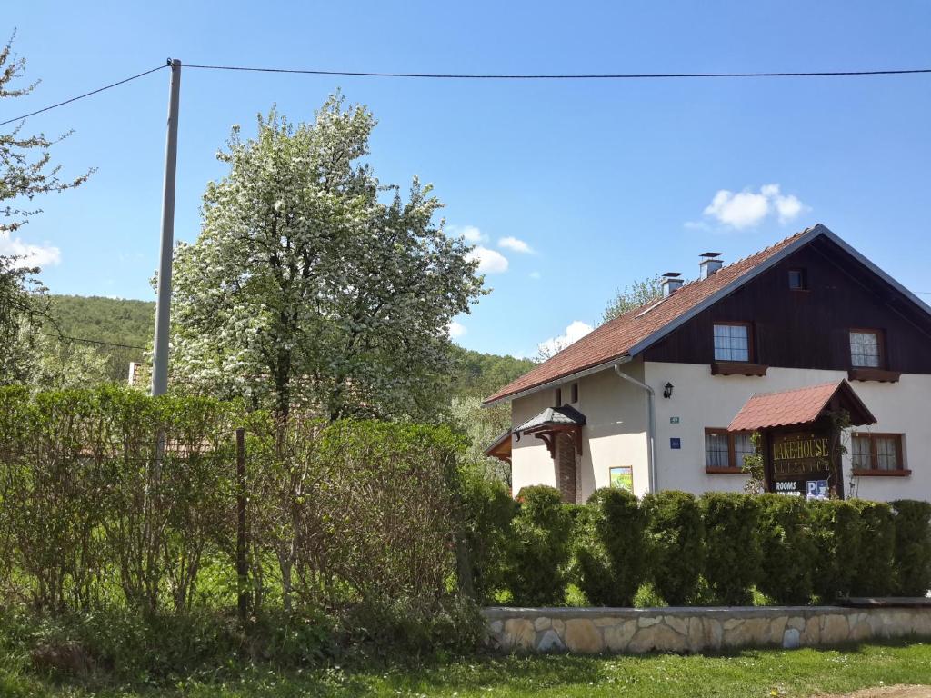 a house with a fence in front of it at Lake House 1 in Plitvička Jezera
