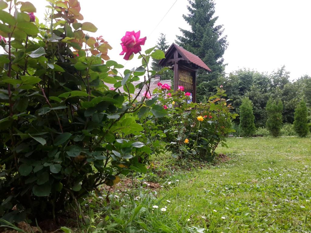a garden with a bird house and flowers at Lake House 1 in Plitvička Jezera