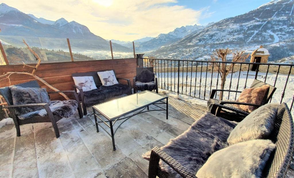 a balcony with chairs and a table and a view of mountains at Panorama apartment Briancon in Briançon