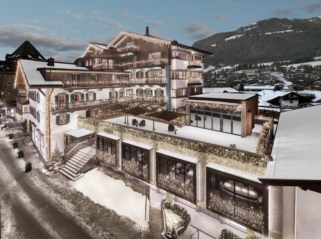 a rendering of a building with snow on the ground at Hotel Weißes Rössl in Kitzbühel